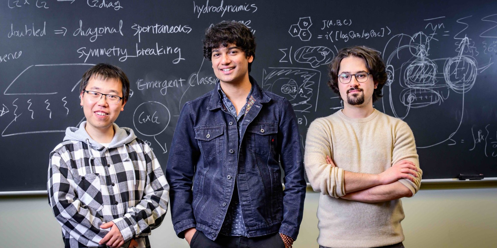 Members of the Lee group in front of a chalkboard